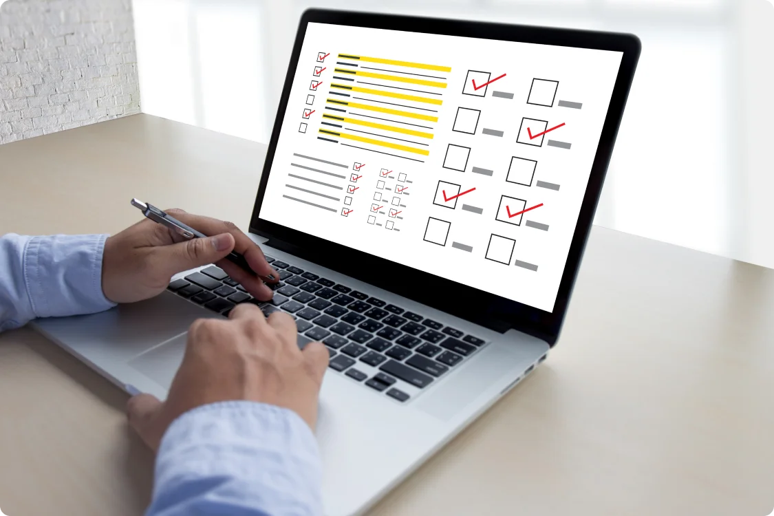 Website Audit and Competitive Analysis being conducted on laptop computer with checklist